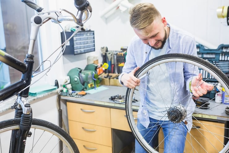 Man checking a tricycle tire