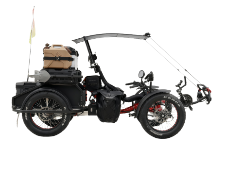 Electric 4WD recumbent trike riding on rugged off-road terrain
